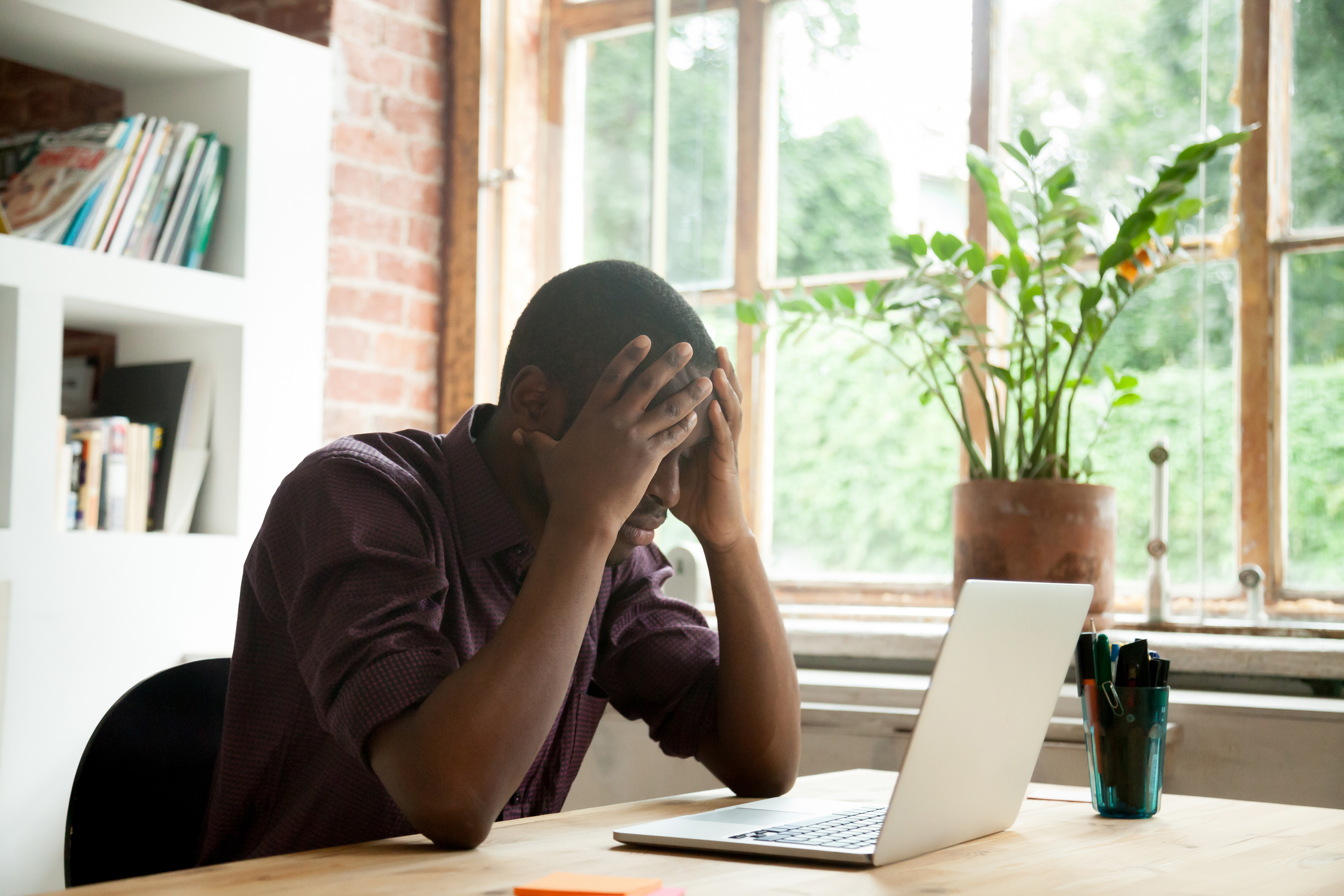 Frustrated black worker disappointed with company crisis